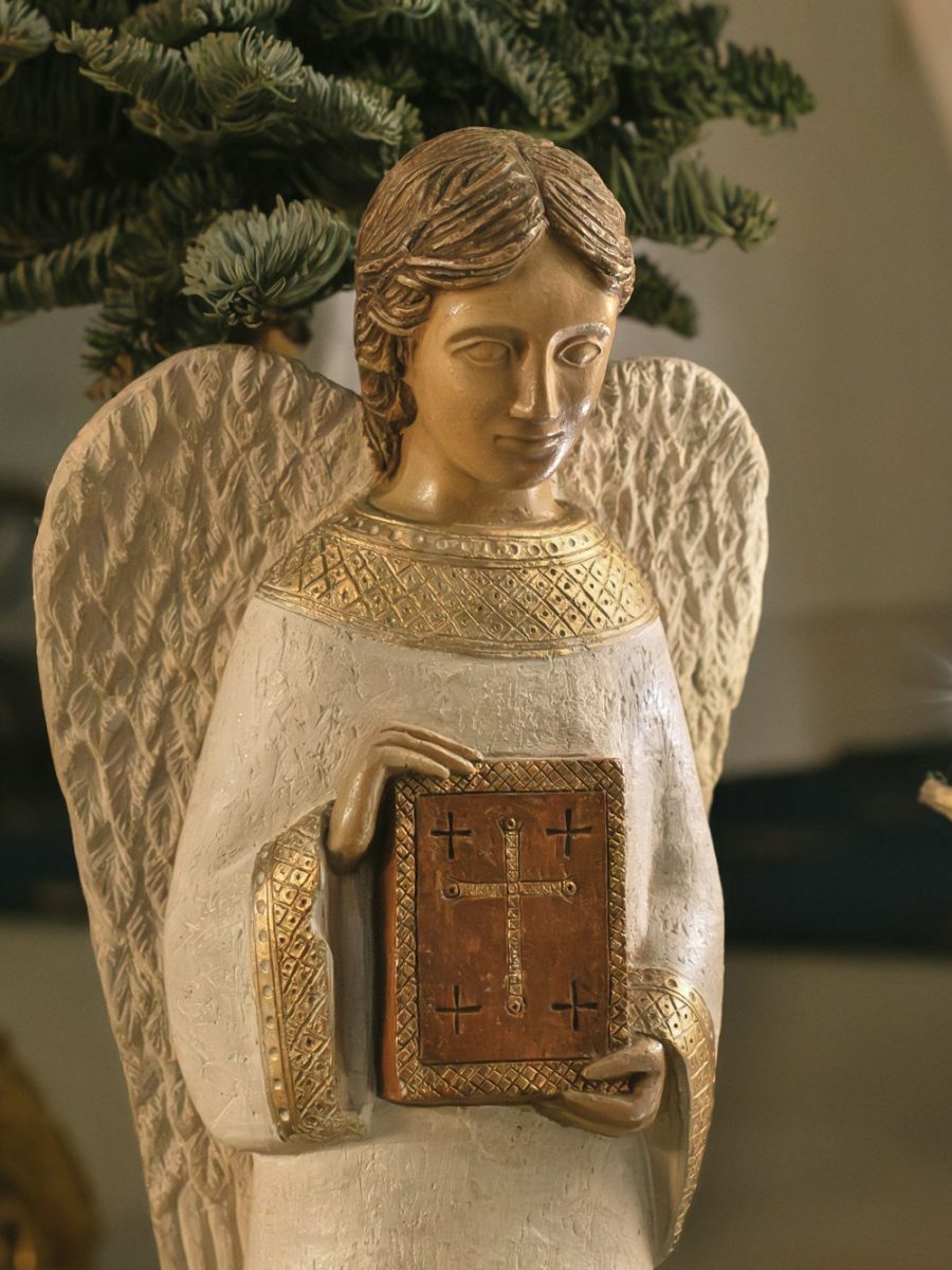 Angel with wings holds a bible Scene of the birth of Jesus Christ Angel with wings holds a bible Scene of the birth of Jesus Christ