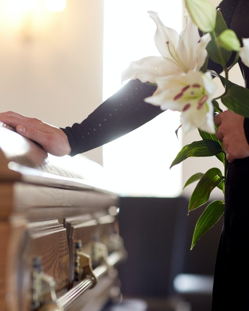 woman-with-lily-flowers-and-coffin-at-funeral.jpg woman-with-lily-flowers-and-coffin-at-funeral.jpg